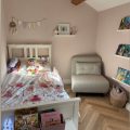 A cozy cottage interior with Chartwell Stone flooring, emphasizing its rustic charm and warm, natural tones. The space is styled with inviting decor, creating a homely ambiance.