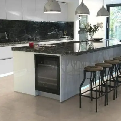 A kitchen with T5000 Ivory Travertine flooring from Pro-Tek™ Flooring. The image displays the warm, ivory-coloured travertine tiles, adding a touch of sophistication and brightness to the space.