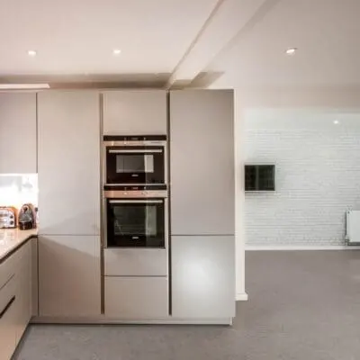 A modern kitchen with T8000 Kitchen Grey Travertine flooring from Pro-Tek™ Flooring. The image showcases the elegant grey travertine tiles, highlighting their sleek and contemporary look.