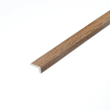 A detailed photograph of the Hever Oak L-shape profile. This piece features a rich oak colour with distinct wood grain patterns, suitable for providing a neat finish to the edges of flooring installations.