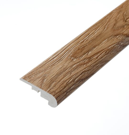 A close-up view of the Hever Oak stair nosing profile. This piece, featuring a warm oak colour with natural grain patterns, is crafted to protect stair edges and provide a smooth transition between steps.