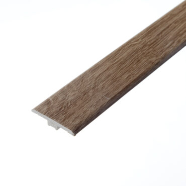 An image of the Ezra Mink T-profile. The piece features a warm, mink-toned finish with subtle wood grain patterns, designed to join two floors of the same height seamlessly.