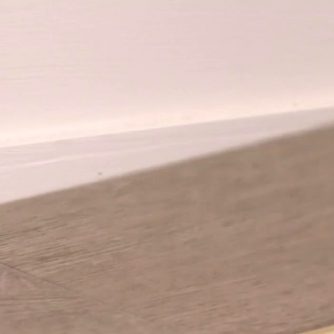 Floor Measurement Guide: An illustrative image demonstrating how to measure a floor accurately, featuring essential tools like a tape measure and pencil, aiding in the planning of flooring installations.